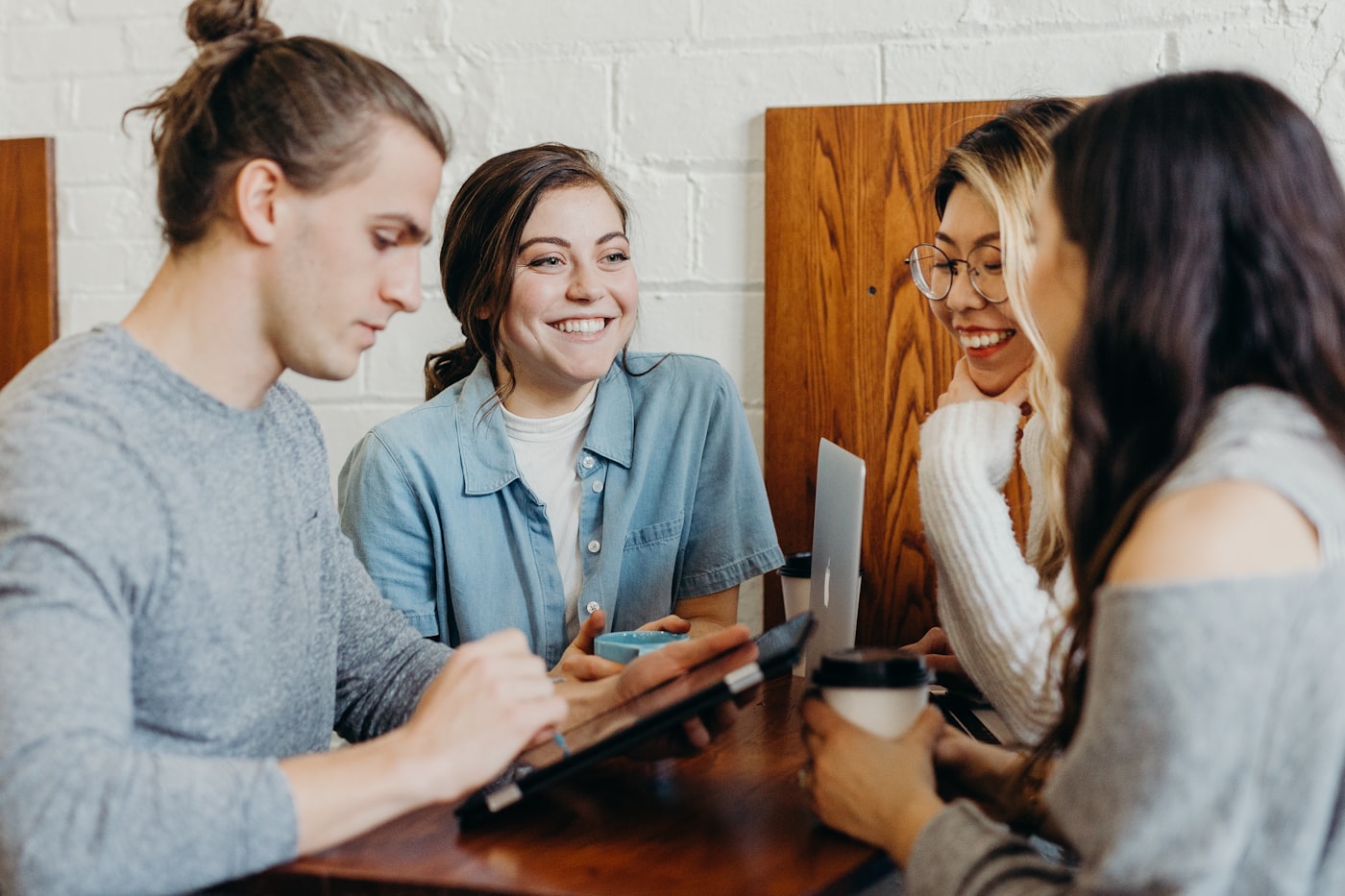 Grupo de clientes sorrindo enquanto planeja junto em uma mesa